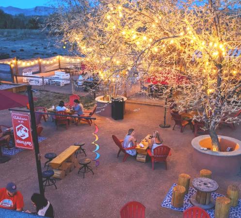 People sitting around fires at Highland's Distillery