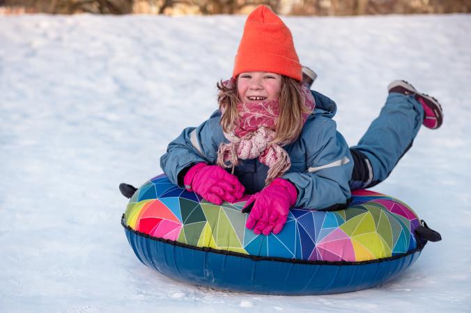 Girl Laying on a Snow Tube