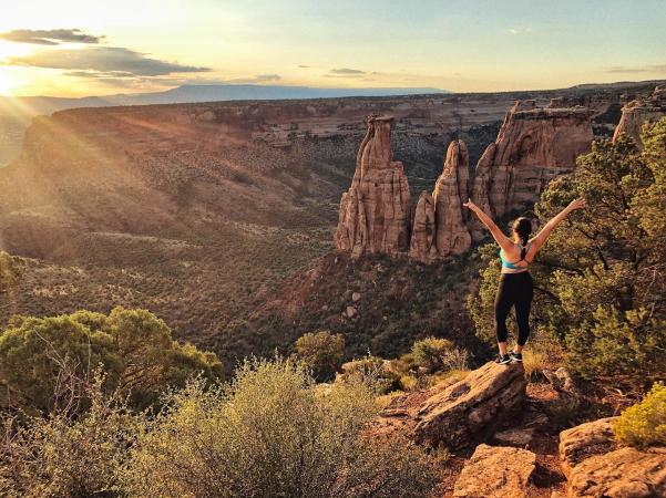 Woman Standing In Colorado National Monument During Sunrise