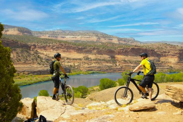 Two mountain bikers overlook the Colorado River