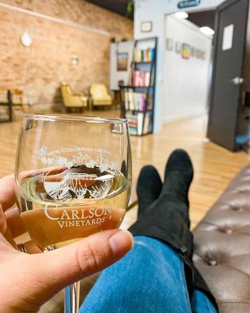 Person Holding a glass of wine and relaxing at Carlson Vineyards Downtown Tasting Room