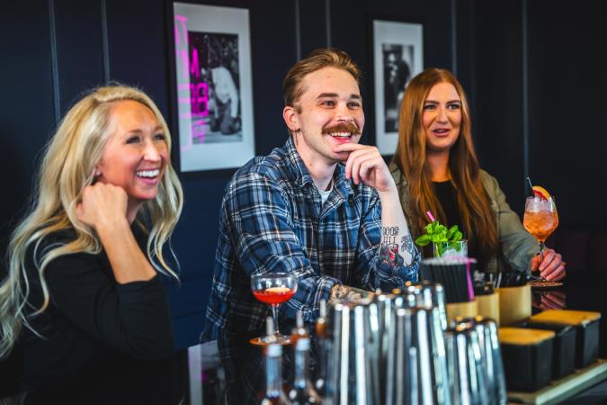 People sitting at bar at melrose spirit co.