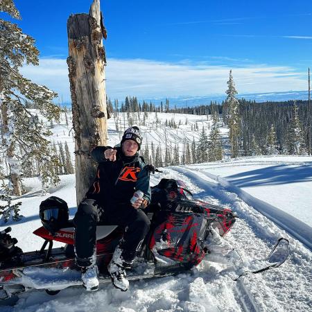Snowmobiler sitting on his Sled on the Grand Mesa