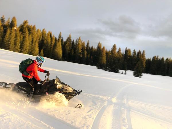 Person Riding a Snowmobile
