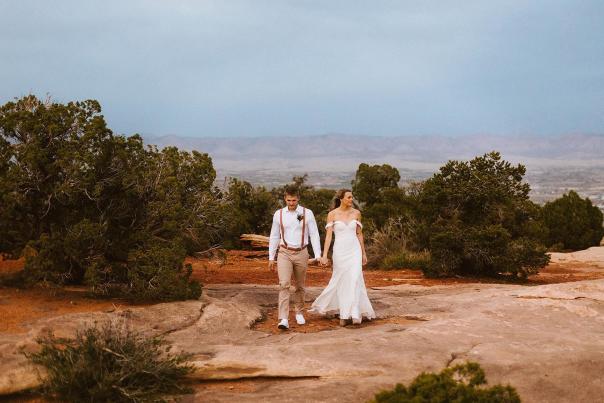 A recently married couple walking in Colorado National Monument