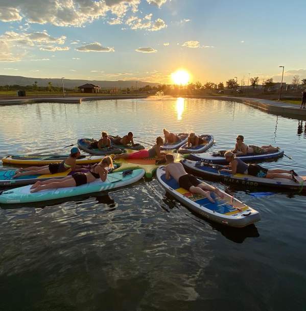 People doing SUP Yoga on Butterfly Lake in Grand Junction