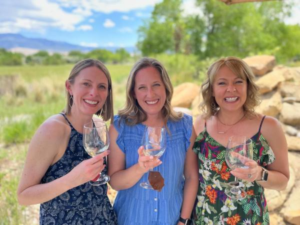 three ladies sipping wine during the summer
