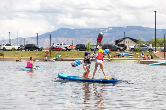 Two Kids Playing on Stand Up Paddleboards