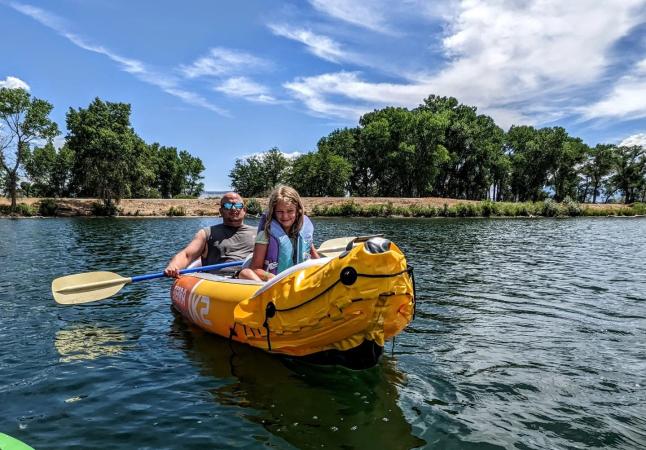Father and daughter in a kayak on Connected Lakes