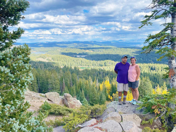 Two people standing at an overlook on the Grand Mesa