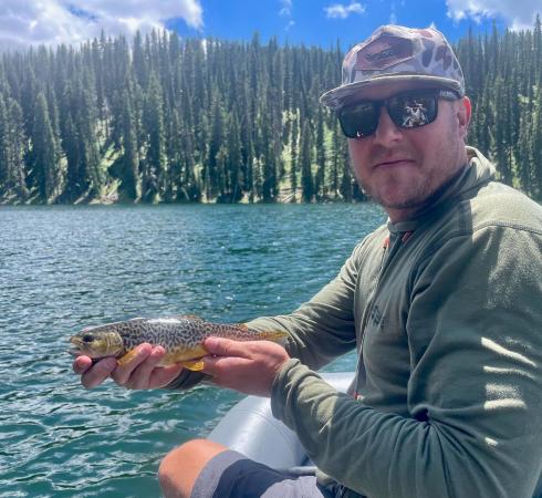 Man Holding a Tiger Trout in a Boat on the Grand Mesa
