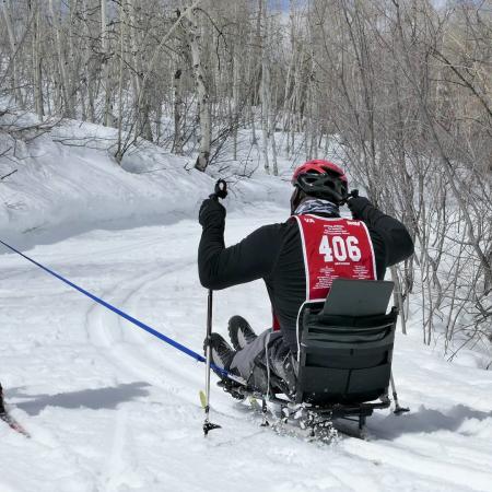 Person cross-country skiing with adaptive equipment