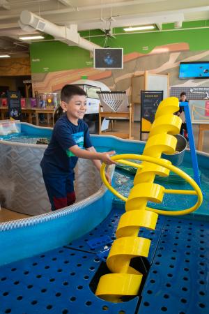 Child Playing With Interactive Exhibit at Eureka! Science Museum