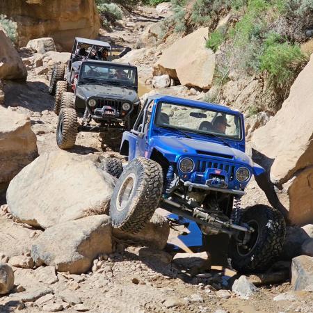 Picture of Three Jeeps Driving Over Big Rocks