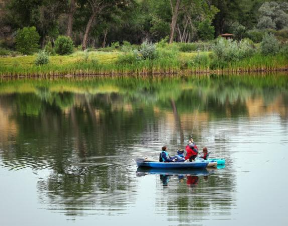 People sitting in Kayaks in Connected Lakes