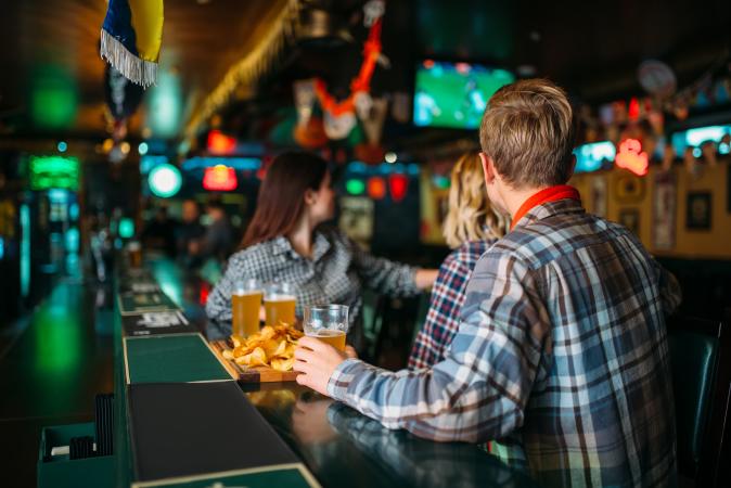 Picture of People Sitting at a Bar Watching Sports